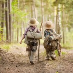 Boys on a forest road with backpacks